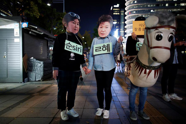 Calls mount to investigate scandal-hit S.Korean president