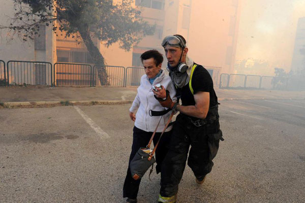 Tens of thousands flee fires as Israeli leaders blame Arab minority for arson