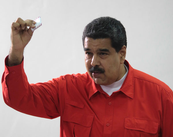 Venezuela's leader casts unusual vote, decries 'terrorism'